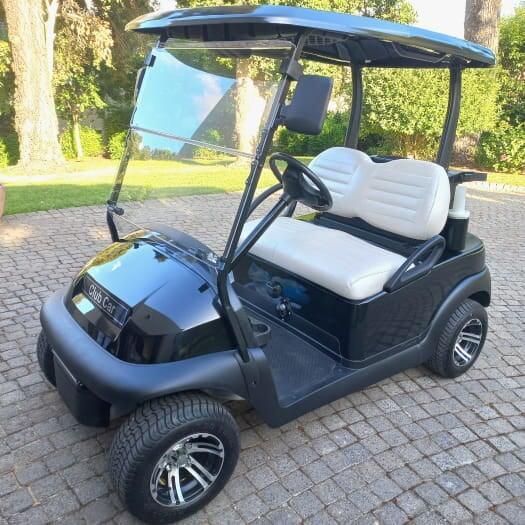 A refurbished club car with a new spray paint and fitted custom upholstery installed.