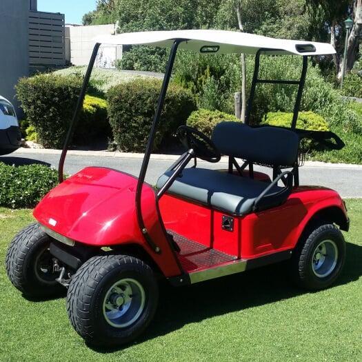 fully refurbished red golf cart, meticulously restored to like-new condition and ready for sale.