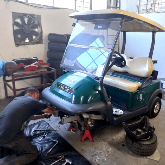 The Golf Carts & All team fully servicing a four-seater golf cart