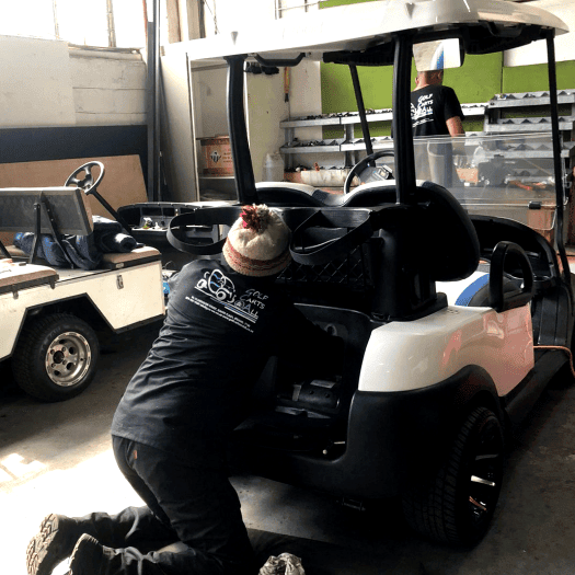 A Golf Carts & All team member performing a full service on an electric golf cart