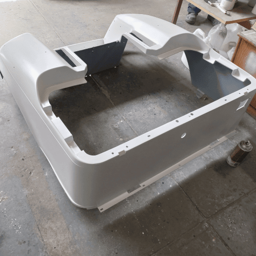 A Golf Carts & All team member carefully disassembling a golf cart to respray each component with precision.